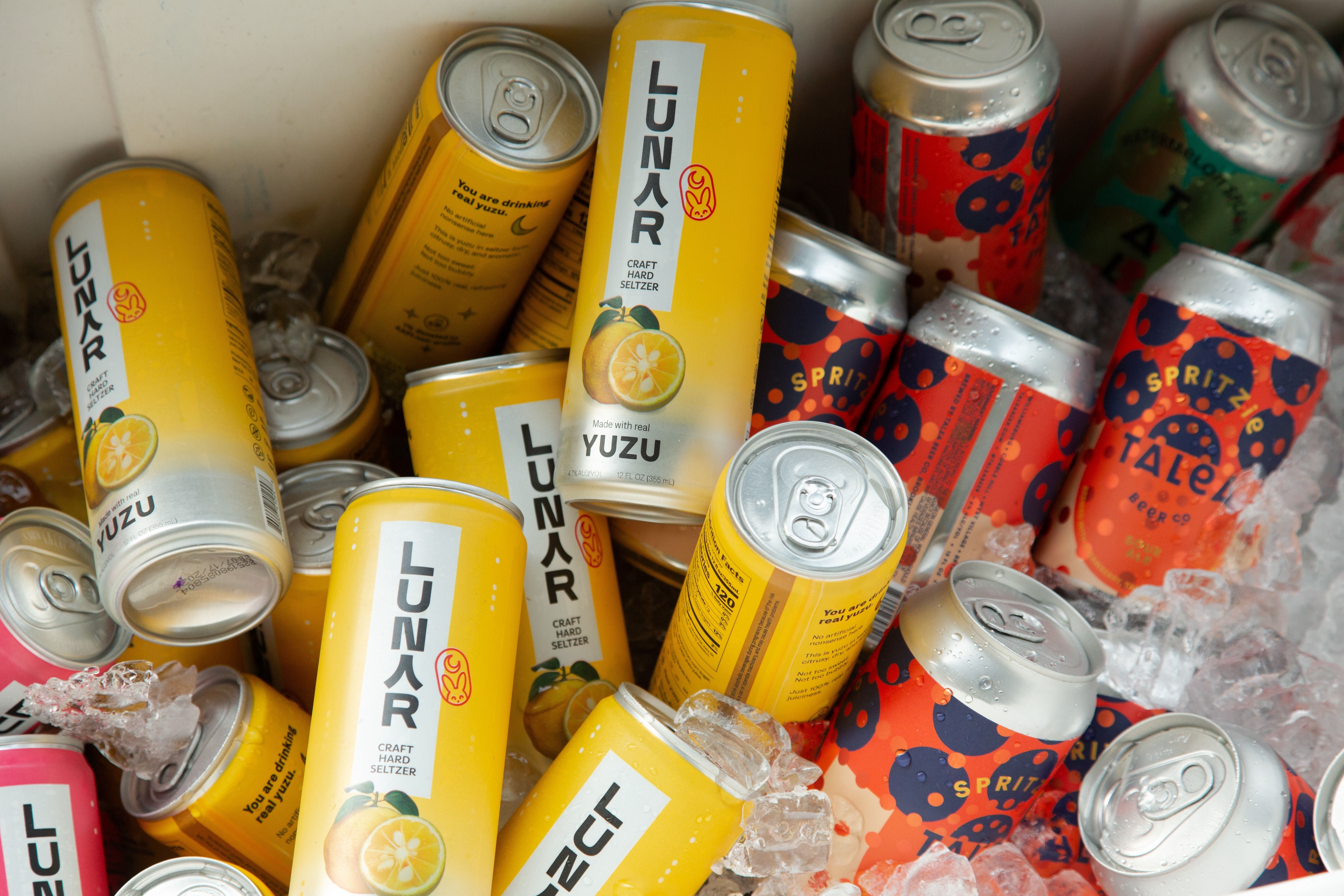 Yellow Lunar Hard Selter cans in a cooler with ice.