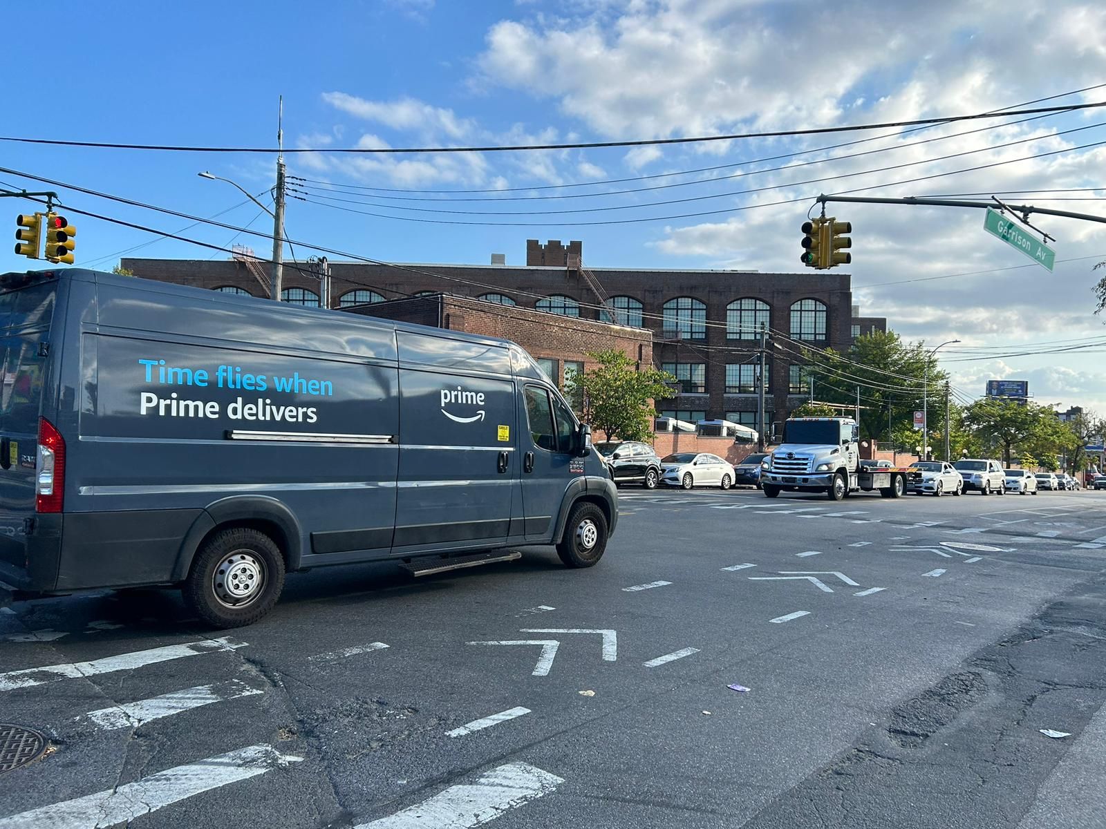 Amazon delivery van that says "Time Flies when Prime delivers" crosses Garrison Ave in the Bronx